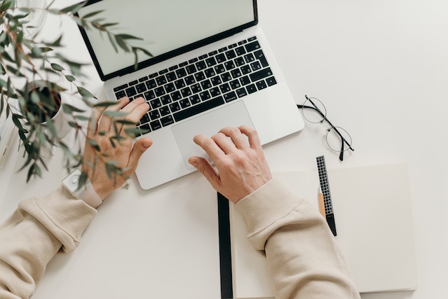 property-manager-typing-on-laptop-on-desk