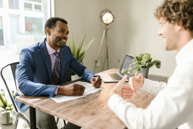 accountant-and-client-speaking-while-sitting-at-desk