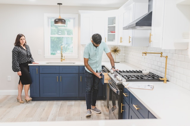 person looking inside kitchen drawer of empty house