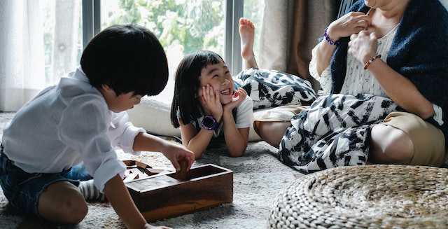 mother and two children playing indoors